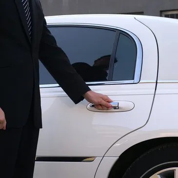 Professional chauffeur with luxury vehicle